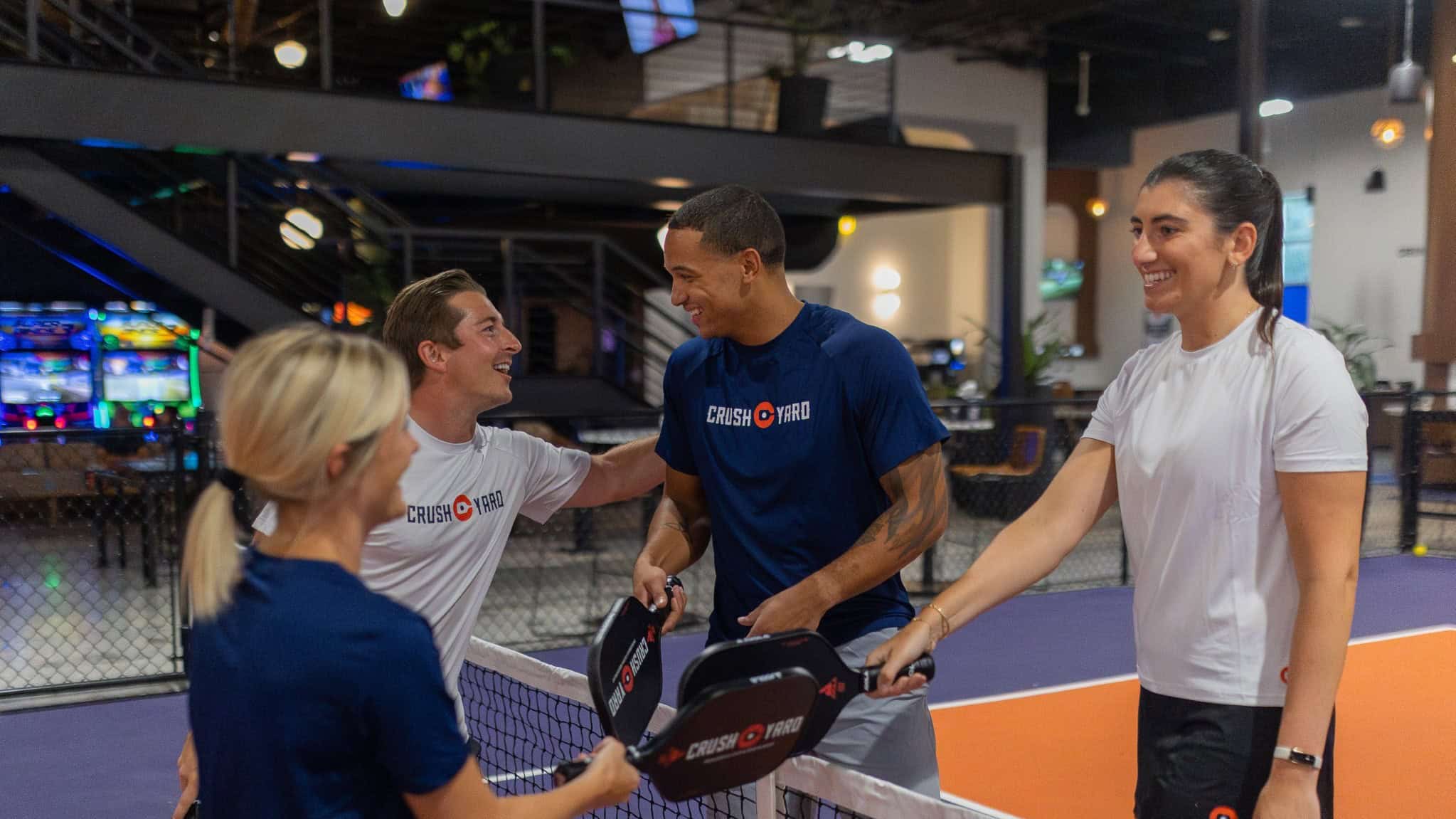 Pickleball players meeting at the net after a game