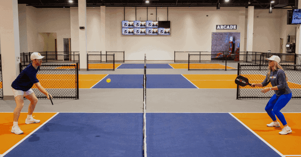 Two players rallying on a Crush Yard pickleball court